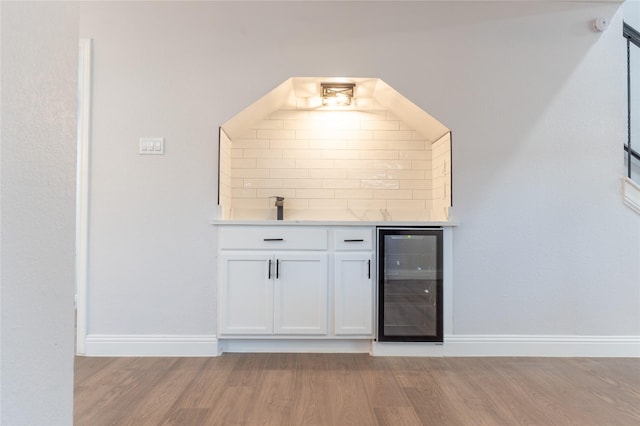 2123 Wheaton Dr, Richardson, TX 75081 - indoor bar featuring beverage cooler, light wood finished floors, tasteful backsplash, and baseboards