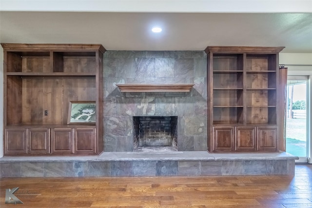 5626 Meadow Dr, Abilene, TX 79606 - unfurnished living room with wood finished floors and a tile fireplace