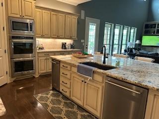 470 Granite Way, Jacksboro, TX 76458 - kitchen with stainless steel appliances, a sink, dark wood-type flooring, open floor plan, and light stone countertops