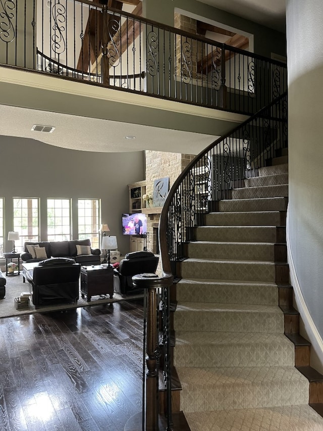470 Granite Way, Jacksboro, TX 76458 - staircase featuring a high ceiling, wood finished floors, and a large fireplace