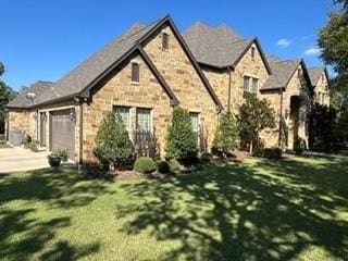 470 Granite Way, Jacksboro, TX 76458 - view of front facade with stone siding, concrete driveway, an attached garage, and a front yard