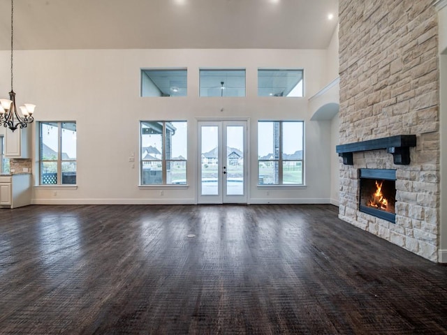 4604 Donna Ln, Parker, TX 75002 - unfurnished living room featuring a chandelier, a fireplace, plenty of natural light, a high ceiling, and baseboards