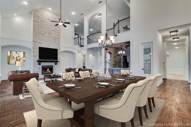4604 Donna Ln, Parker, TX 75002 - dining room with a high ceiling, a fireplace, a ceiling fan, arched walkways, and baseboards