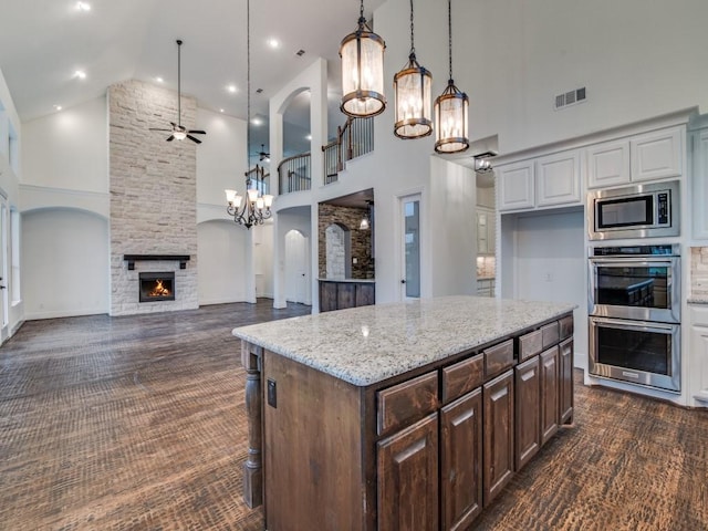 4604 Donna Ln, Parker, TX 75002 - kitchen featuring high vaulted ceiling, appliances with stainless steel finishes, dark colored carpet, a ceiling fan, and a fireplace