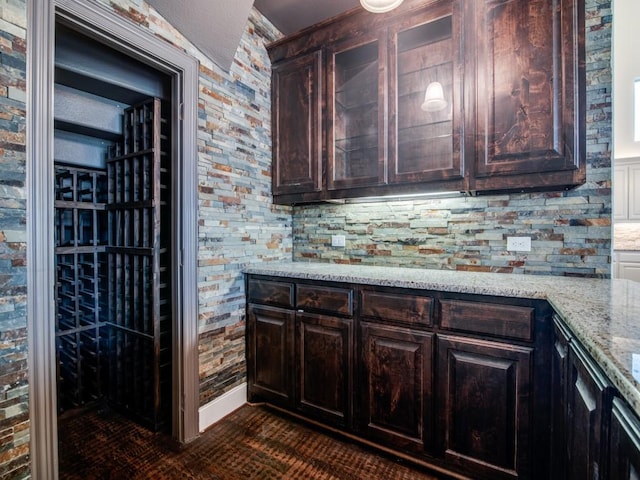 4604 Donna Ln, Parker, TX 75002 - kitchen featuring light stone countertops, dark brown cabinetry, and backsplash