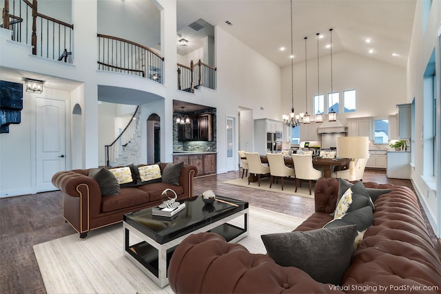 4604 Donna Ln, Parker, TX 75002 - living room featuring a chandelier, high vaulted ceiling, stairway, wood finished floors, and arched walkways