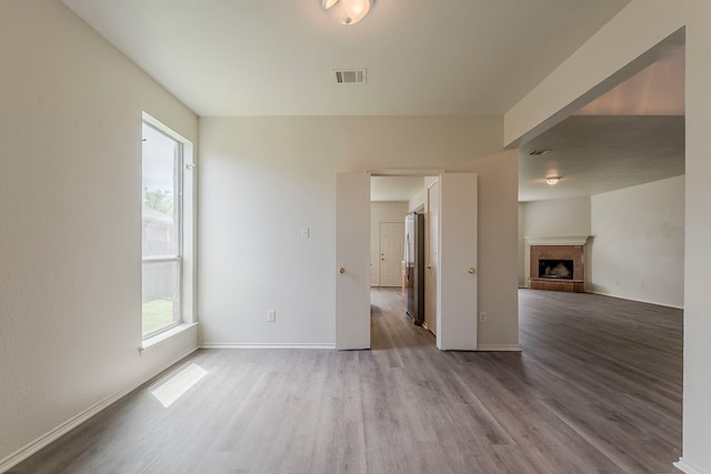 1720 Triumph Trl, Arlington, TX 76002 - unfurnished living room featuring wood finished floors, baseboards, and a fireplace