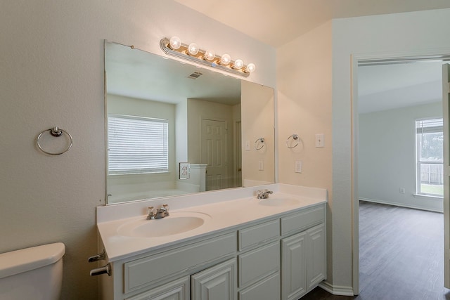1720 Triumph Trl, Arlington, TX 76002 - full bath with toilet, double vanity, and wood finished floors