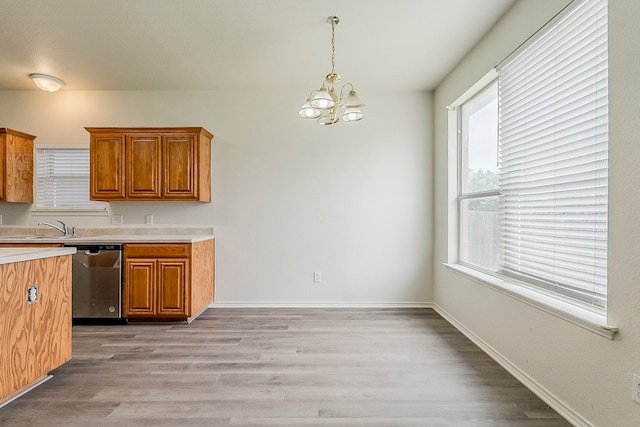 1720 Triumph Trl, Arlington, TX 76002 - kitchen with dishwasher, a chandelier, light wood-style floors, and brown cabinetry