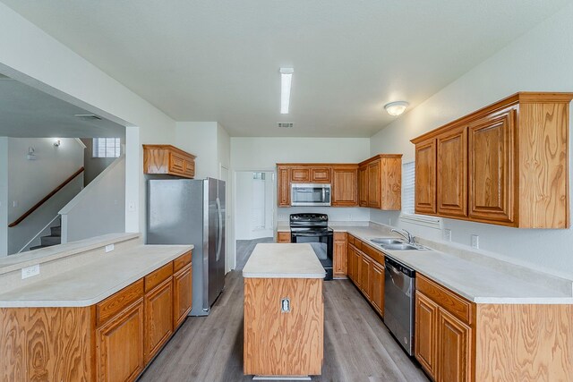 1720 Triumph Trl, Arlington, TX 76002 - kitchen featuring appliances with stainless steel finishes, a sink, light countertops, and brown cabinetry