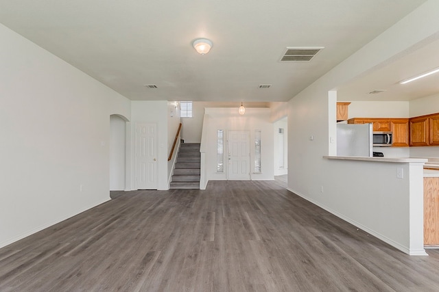 1720 Triumph Trl, Arlington, TX 76002 - unfurnished living room with wood finished floors, stairs, and baseboards