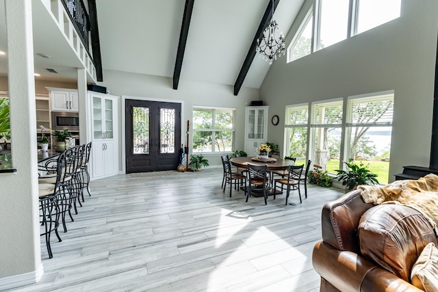 8799 County Road 299, Possum Kingdom Lake, TX 76450 - dining space featuring french doors, high vaulted ceiling, beam ceiling, light wood-type flooring, and baseboards