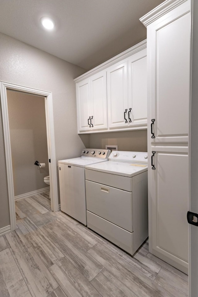 8799 County Road 299, Possum Kingdom Lake, TX 76450 - washroom with washer and dryer, cabinet space, light wood-style flooring, recessed lighting, and baseboards
