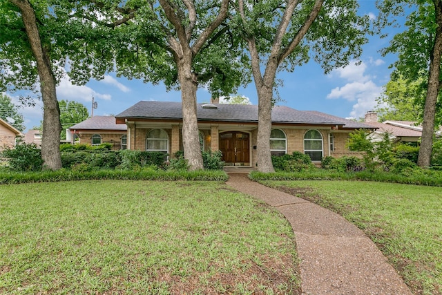 2412 Crestview Cir, Irving, TX 75062 - ranch-style home featuring brick siding, a front lawn, a chimney, and a shingled roof