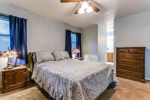 2412 Crestview Cir, Irving, TX 75062 - bedroom with light carpet, a ceiling fan, and ensuite bath