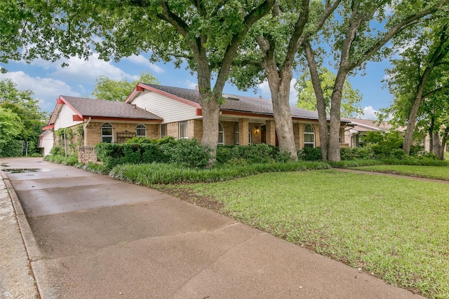 2412 Crestview Cir, Irving, TX 75062 - ranch-style home with brick siding, a front lawn, and concrete driveway
