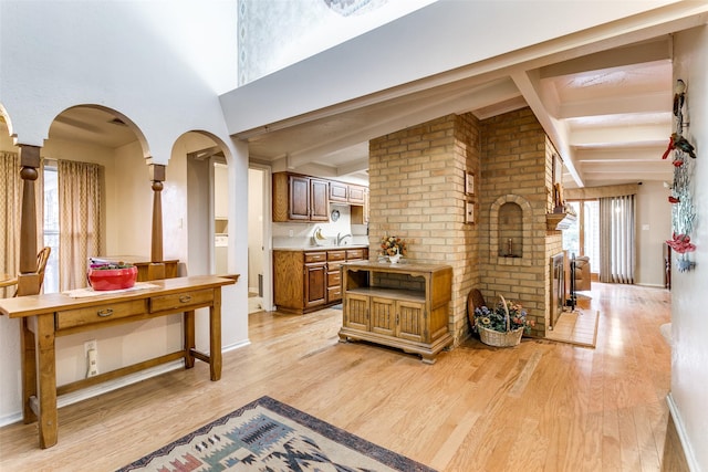2412 Crestview Cir, Irving, TX 75062 - corridor with light wood-style flooring, beam ceiling, arched walkways, and baseboards