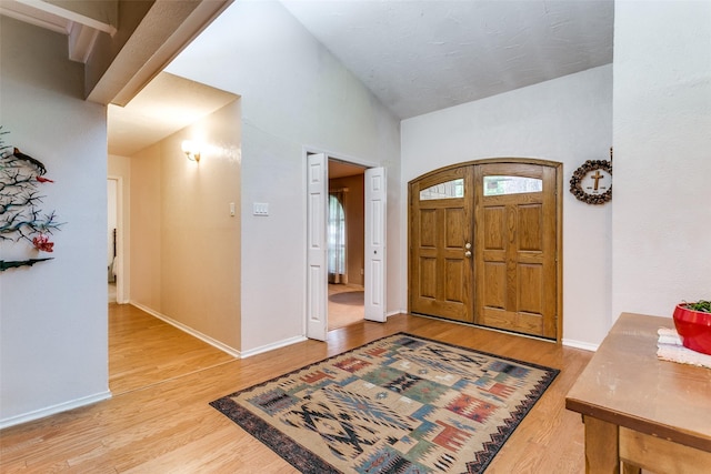 2412 Crestview Cir, Irving, TX 75062 - foyer entrance with wood finished floors, baseboards, and vaulted ceiling