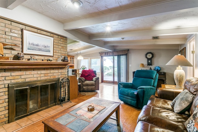 2412 Crestview Cir, Irving, TX 75062 - living room featuring light wood finished floors, a fireplace, and ornamental molding