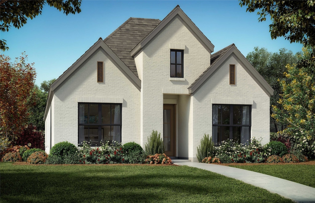 644 Caprice Blf, Fate, TX 75189 - view of front of home with brick siding, a front lawn, and roof with shingles