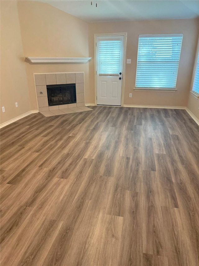 716 Riverhead Dr, Wylie, TX 75098 - unfurnished living room featuring a fireplace, wood finished floors, plenty of natural light, and baseboards