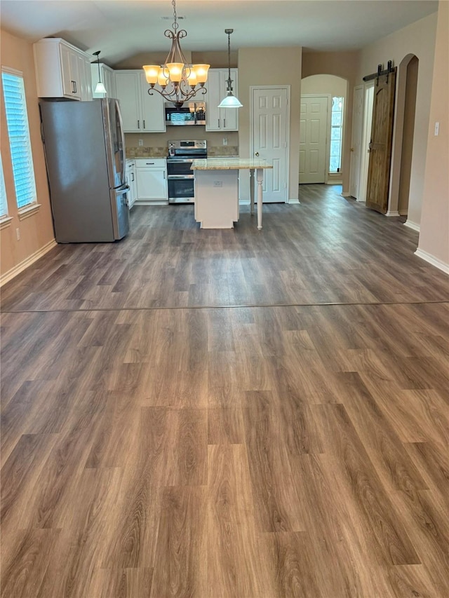 716 Riverhead Dr, Wylie, TX 75098 - kitchen with stainless steel appliances, arched walkways, baseboards, and white cabinetry