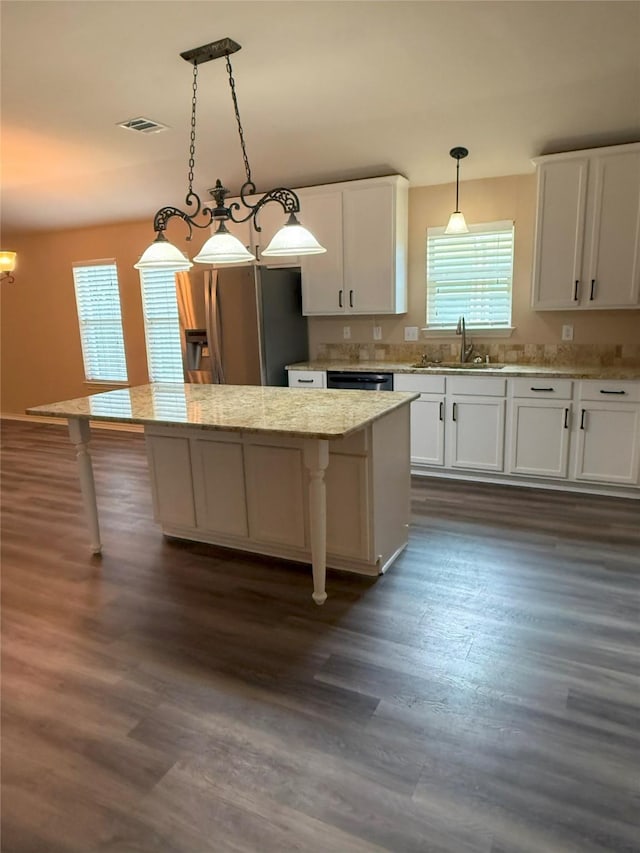 716 Riverhead Dr, Wylie, TX 75098 - kitchen with a sink, a kitchen island, a kitchen breakfast bar, and dark wood-style flooring