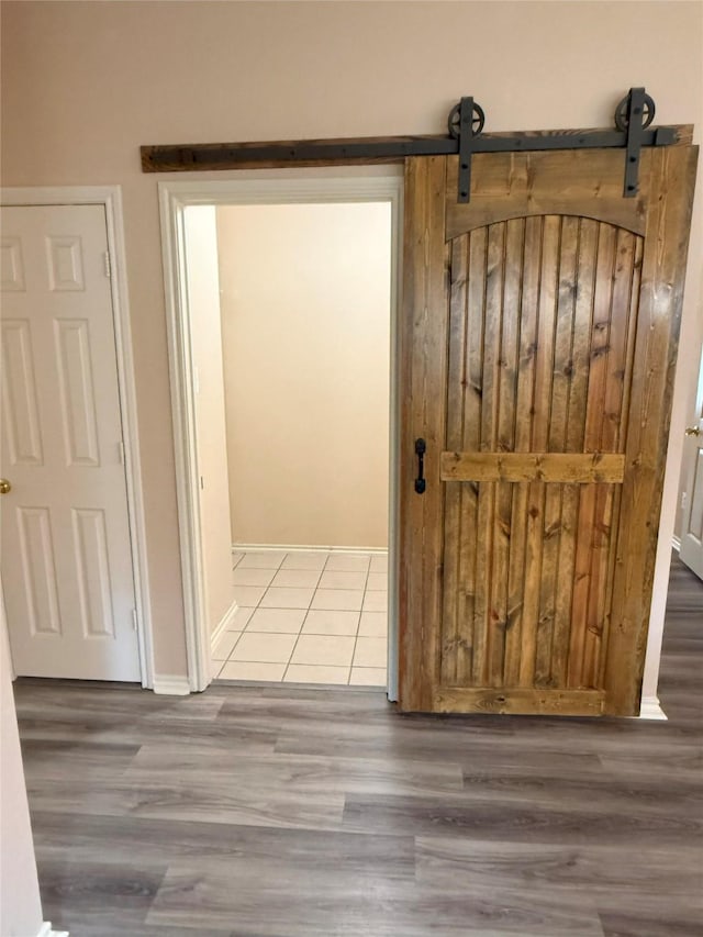 716 Riverhead Dr, Wylie, TX 75098 - hallway featuring wood finished floors, baseboards, and a barn door