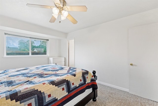carpeted bedroom with baseboards and a ceiling fan