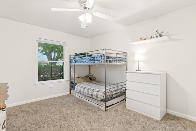bedroom featuring light carpet, baseboards, and ceiling fan