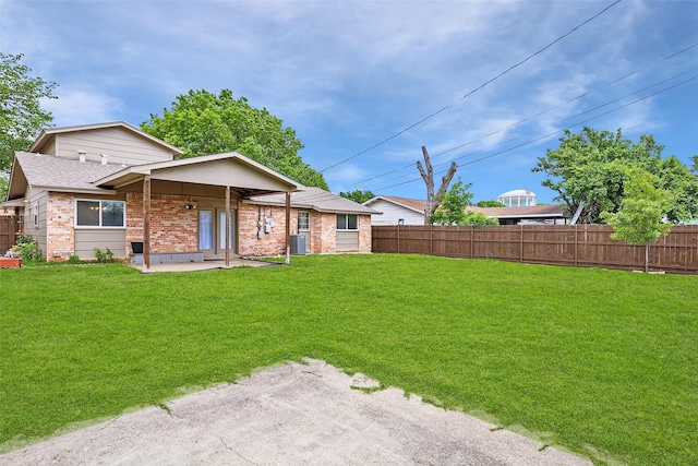 rear view of house featuring brick siding, central air condition unit, a patio area, and roof with shingles