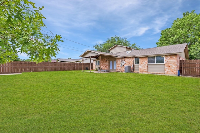 rear view of property with central air condition unit, brick siding, and roof with shingles
