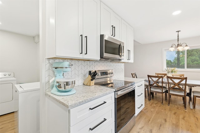 kitchen with stainless steel appliances, washer / clothes dryer, light wood finished floors, and recessed lighting
