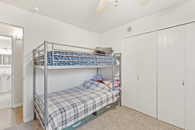 carpeted bedroom with a closet and a ceiling fan