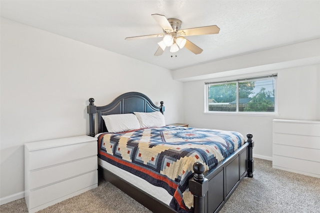 bedroom featuring light carpet, baseboards, and ceiling fan