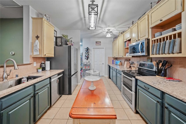 1412 Millbrook Ln, Wylie, TX 75098 - kitchen with stainless steel appliances, a sink, decorative backsplash, and light countertops