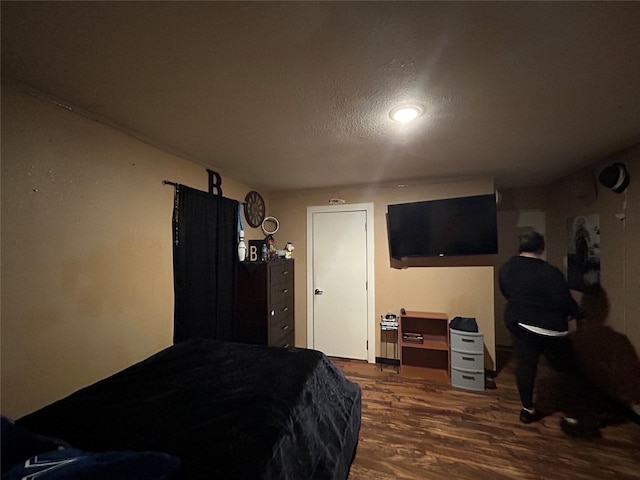 1209 E Tucker St, Fort Worth, TX 76104 - bedroom featuring dark wood finished floors and a textured ceiling