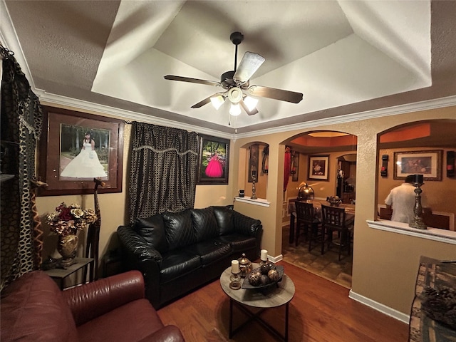 1209 E Tucker St, Fort Worth, TX 76104 - living area with a raised ceiling, arched walkways, ceiling fan, wood finished floors, and ornamental molding