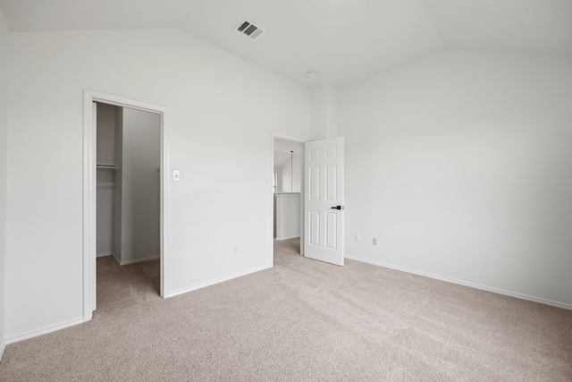 7205 Lake Roberts Way, Arlington, TX 76002 - unfurnished bedroom featuring lofted ceiling, light colored carpet, a spacious closet, and baseboards