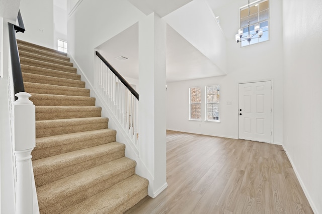 7205 Lake Roberts Way, Arlington, TX 76002 - foyer featuring plenty of natural light, a towering ceiling, stairs, light wood-type flooring, and baseboards