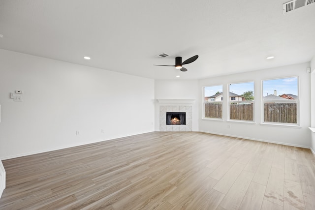 7205 Lake Roberts Way, Arlington, TX 76002 - unfurnished living room featuring ceiling fan, light wood finished floors, a tiled fireplace, baseboards, and recessed lighting