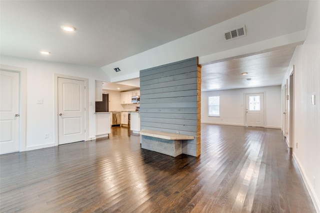 8919 San Fernando Way, Dallas, TX 75218 - unfurnished living room with dark wood finished floors, baseboards, recessed lighting, and lofted ceiling