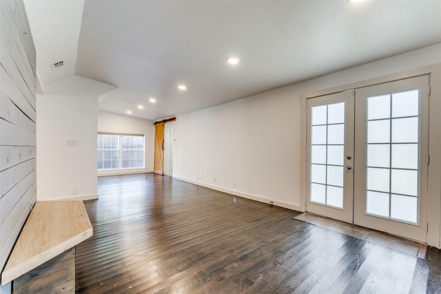 8919 San Fernando Way, Dallas, TX 75218 - unfurnished living room with french doors, a barn door, dark wood-type flooring, recessed lighting, and baseboards