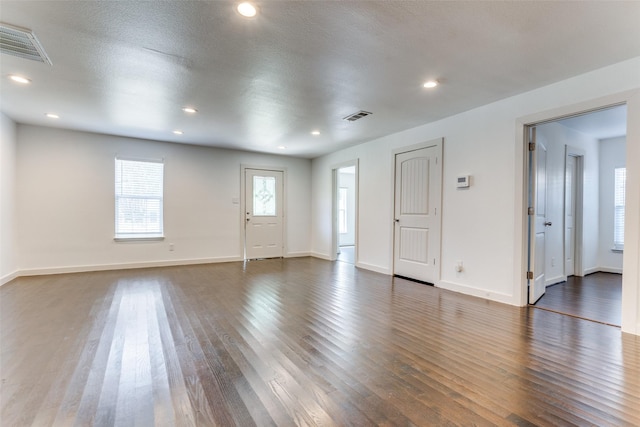 8919 San Fernando Way, Dallas, TX 75218 - unfurnished living room featuring dark wood finished floors, baseboards, and recessed lighting