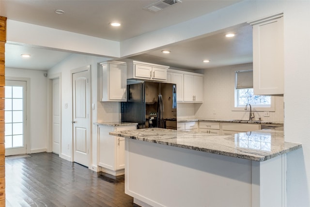 8919 San Fernando Way, Dallas, TX 75218 - kitchen featuring freestanding refrigerator, white cabinetry, dark wood-style flooring, light stone counters, and recessed lighting