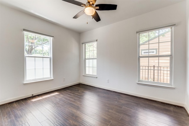 8919 San Fernando Way, Dallas, TX 75218 - unfurnished room featuring ceiling fan, dark wood-type flooring, and baseboards