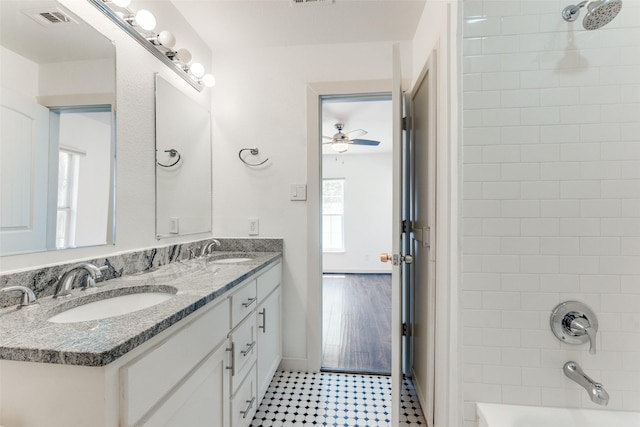 8919 San Fernando Way, Dallas, TX 75218 - full bathroom with ceiling fan, double vanity, tub / shower combination, and baseboards