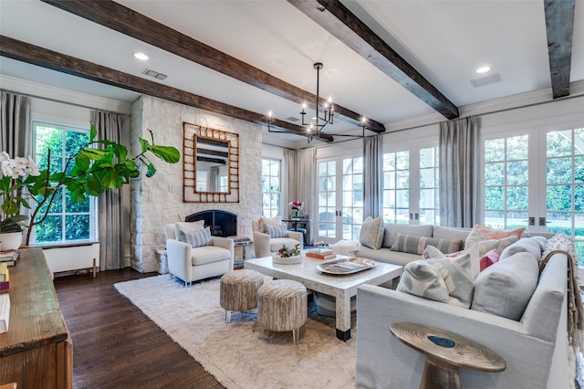 3208 Villanova St, University Park, TX 75225 - living area featuring plenty of natural light, a stone fireplace, dark wood-type flooring, beamed ceiling, and a chandelier