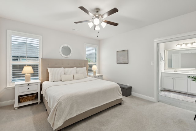 509 Oleander Dr, Royse City, TX 75189 - bedroom featuring light carpet, baseboards, ensuite bathroom, a ceiling fan, and a sink