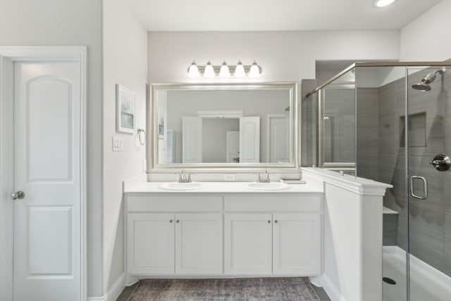 509 Oleander Dr, Royse City, TX 75189 - bathroom with a stall shower, double vanity, and baseboards
